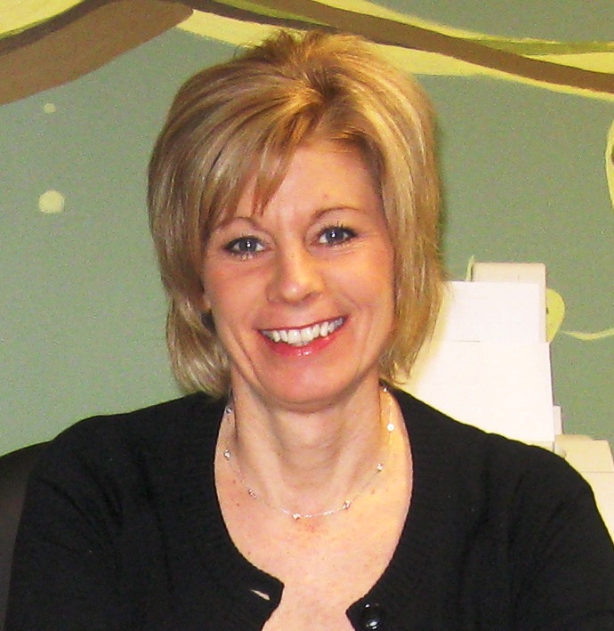 blonde woman in a black top smiling