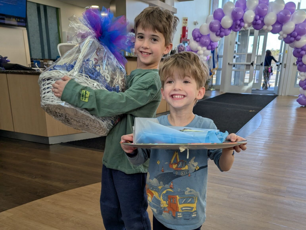 2 kids holding baskets smiling