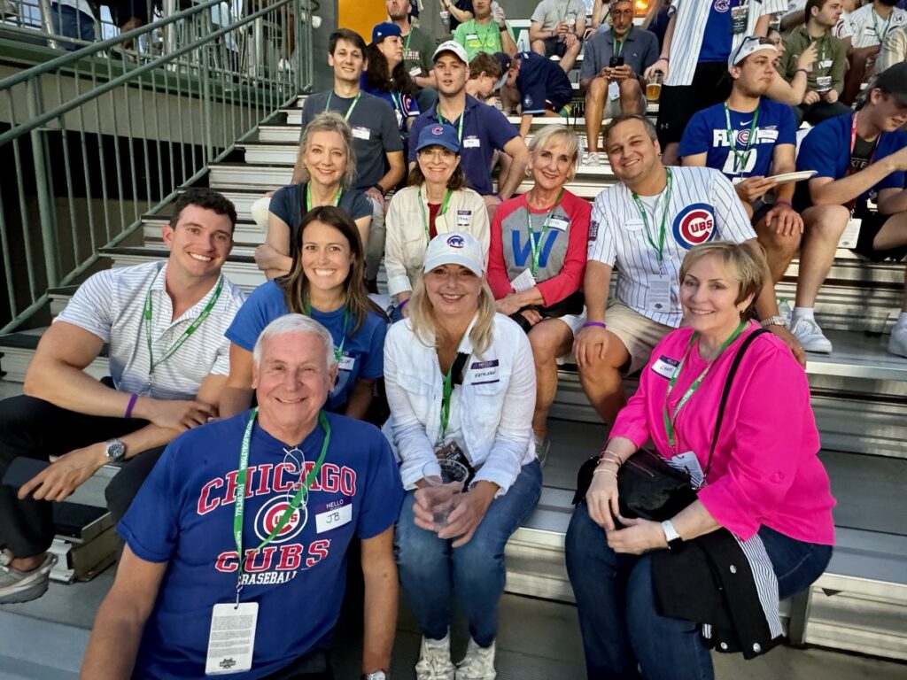 people sitting down on bleachers smiling

Wrigley Rooftop Cubs night