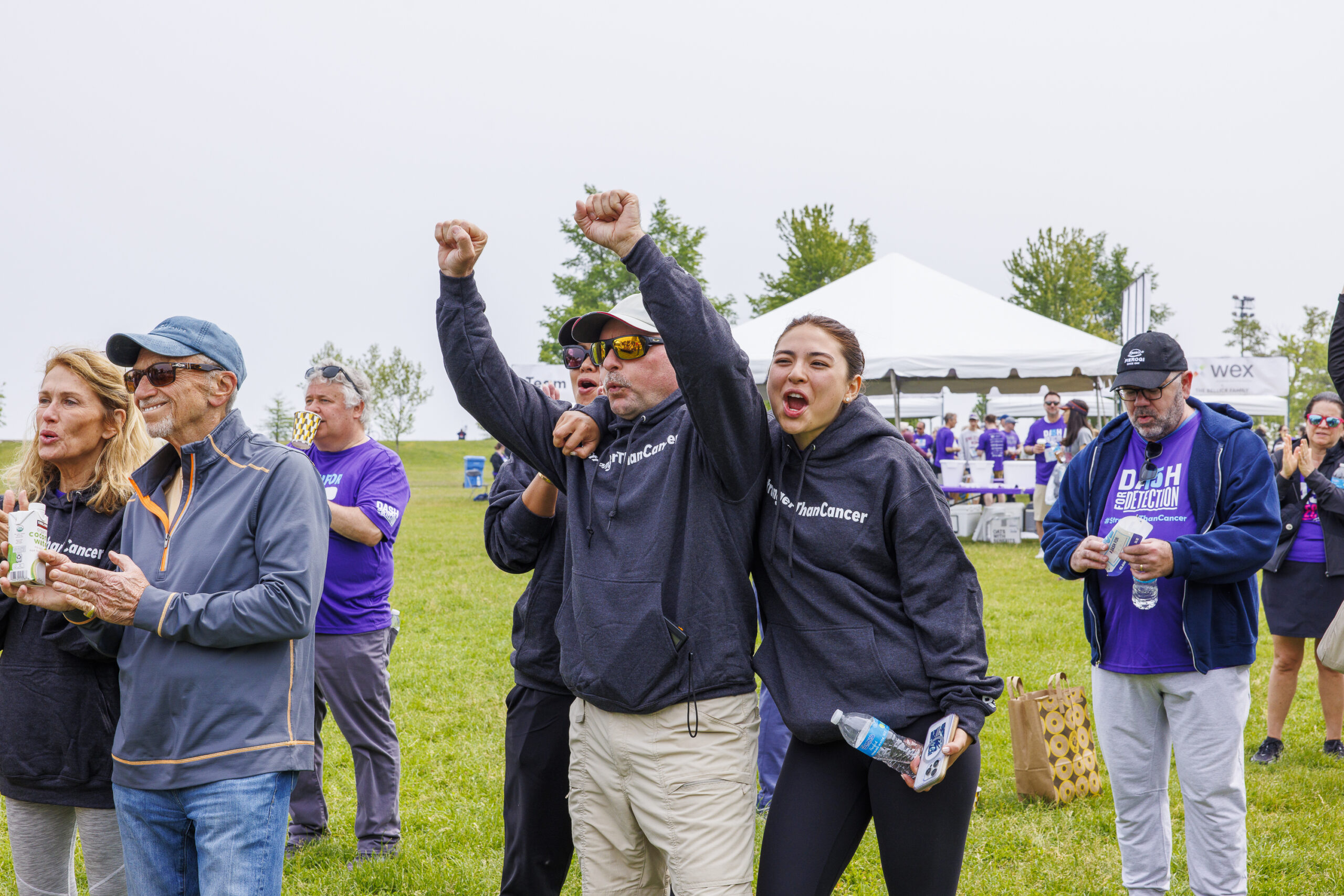 man and woman in rolfe hoodies cheering