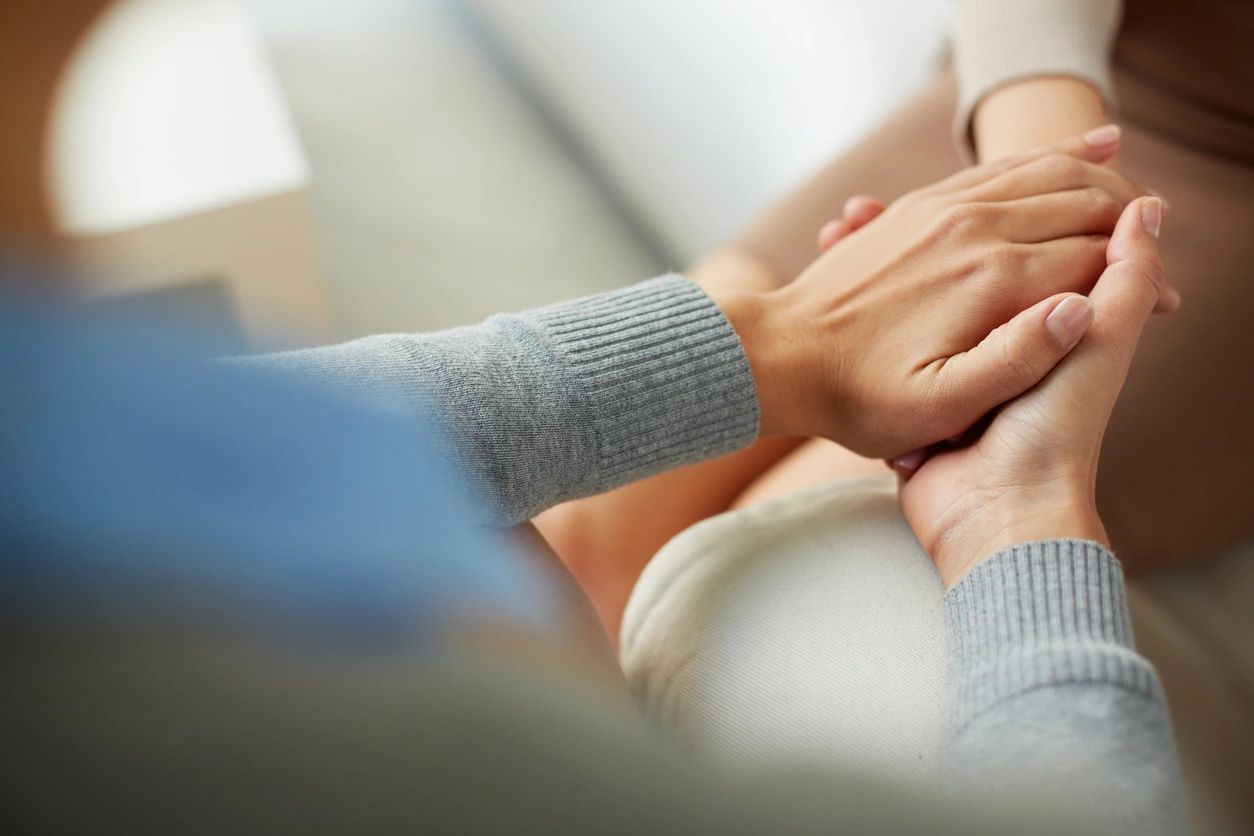 people holding hands for support